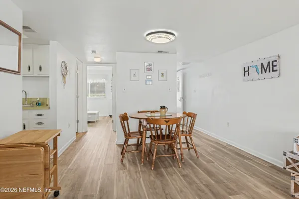 a view of a dining room with furniture and wooden floor