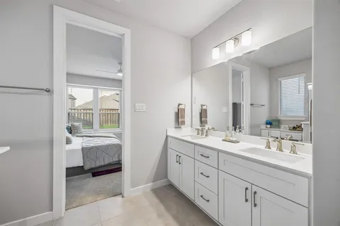a bathroom with a shower sink vanity mirror and toilet