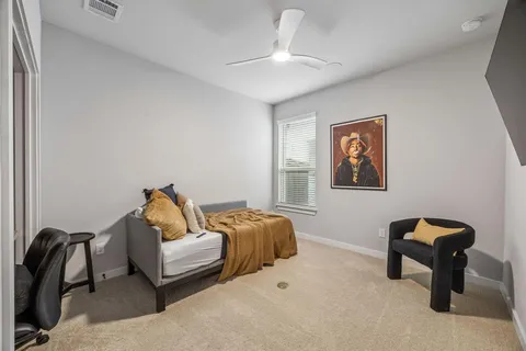 a bedroom with a bed and painting on the wall