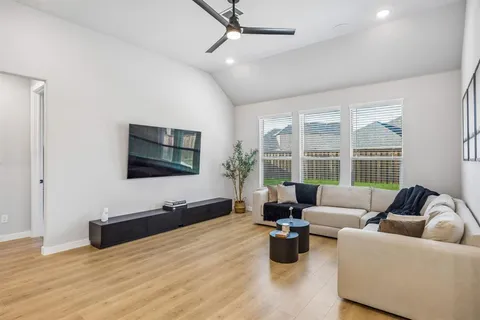 a living room with furniture and kitchen view