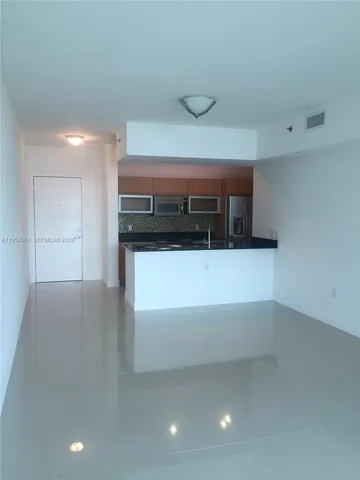 a kitchen with stainless steel appliances a refrigerator and a stove