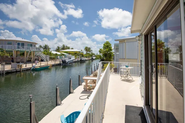 a view of house with roof deck and seating space