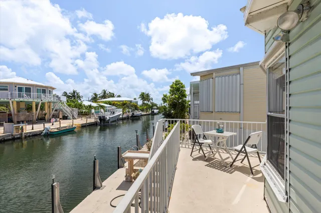 a view of a lake with a table and chairs