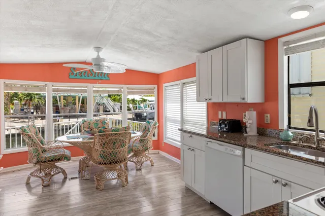 a dining room with furniture a chandelier and wooden floor