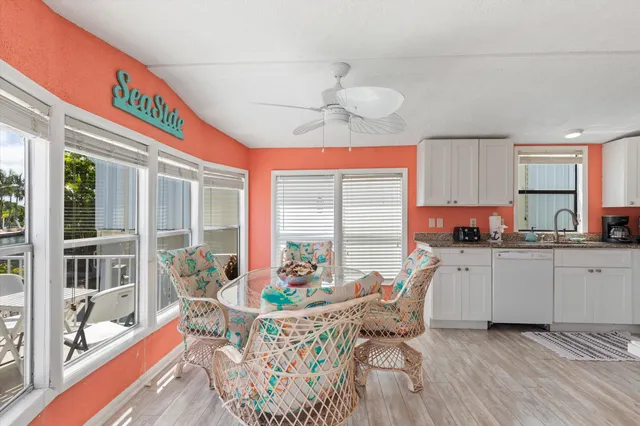 a dining room with furniture a chandelier and wooden floor