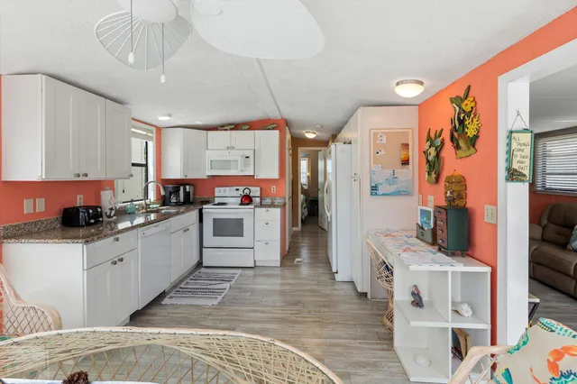 a kitchen with stainless steel appliances a stove a refrigerator and cabinets