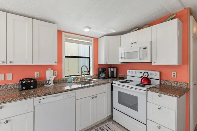 a kitchen with stainless steel appliances a stove sink and refrigerator