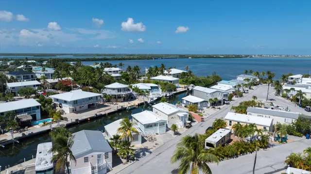 a aerial view of a house with swimming pool and outdoor seating
