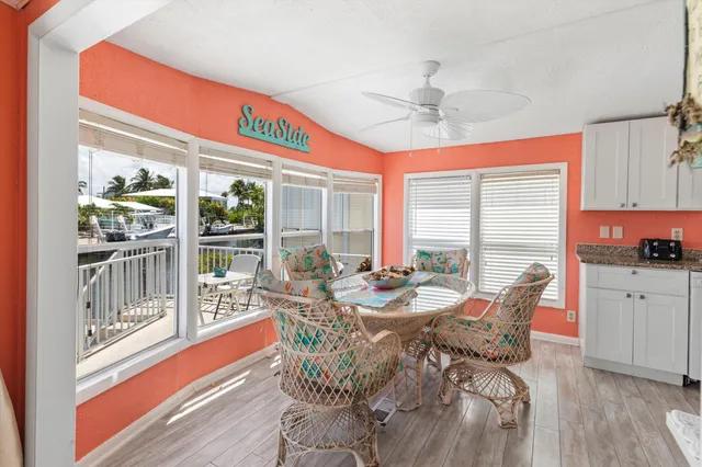 a view of a dining room with furniture large windows and wooden floor