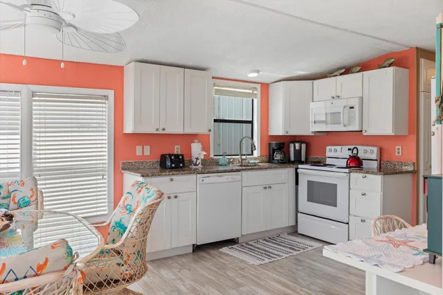 a kitchen with a sink cabinets and window
