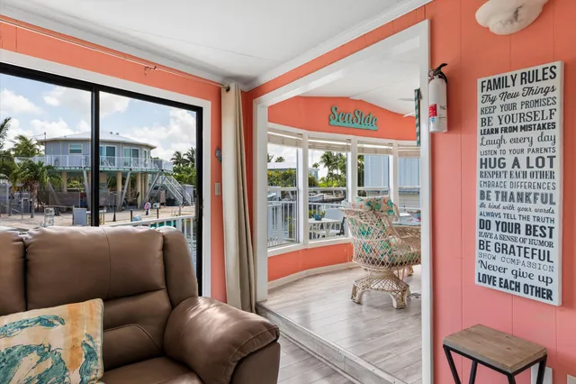 a living room filled with furniture and a large window