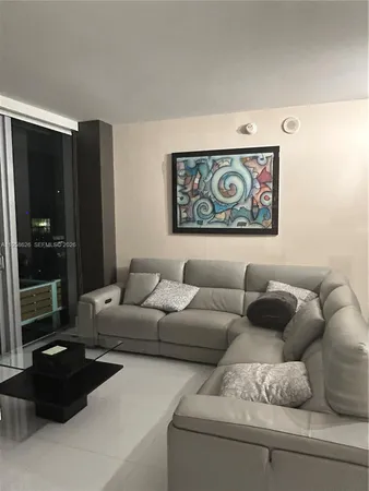 a living room with furniture and a window