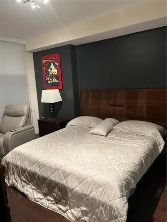 a bedroom with a bed and a potted plant