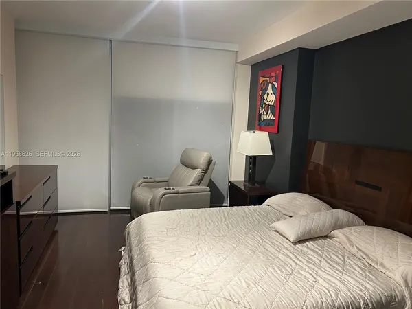 a bedroom with a bed and dresser