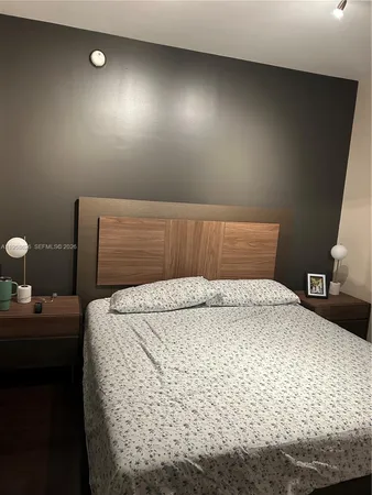 a bedroom with a bed and cabinets