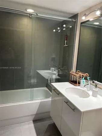 a bathroom with a bathtub and a sink