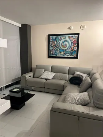 a kitchen with granite countertop a stove and white cabinets