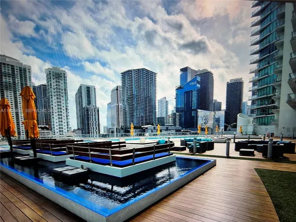 a sitting area with large pool table and furniture