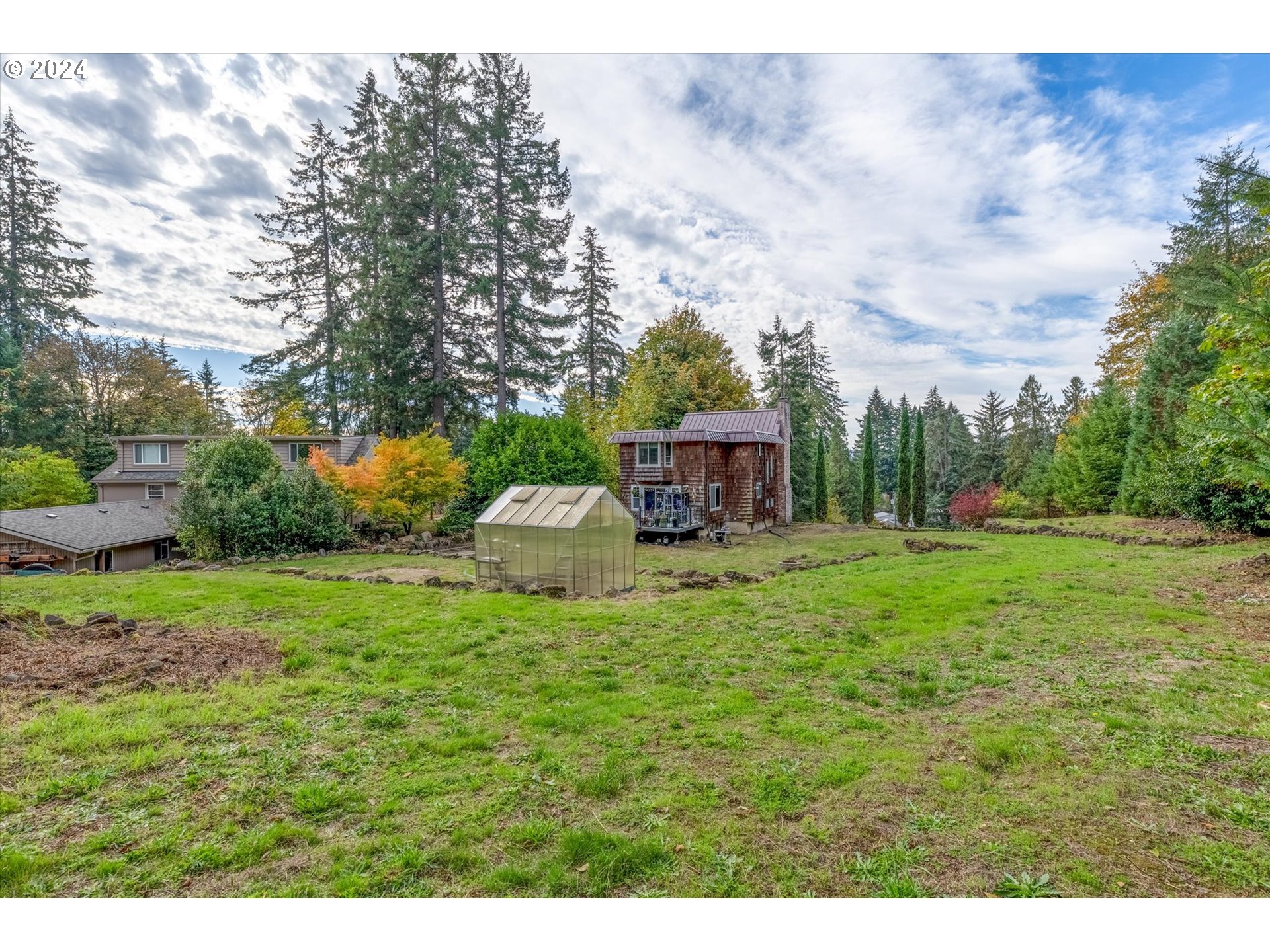3516 Sunset Way Longview, WA 98632 - Photo 34 of 37 a view of a house with backyard sitting area and garden