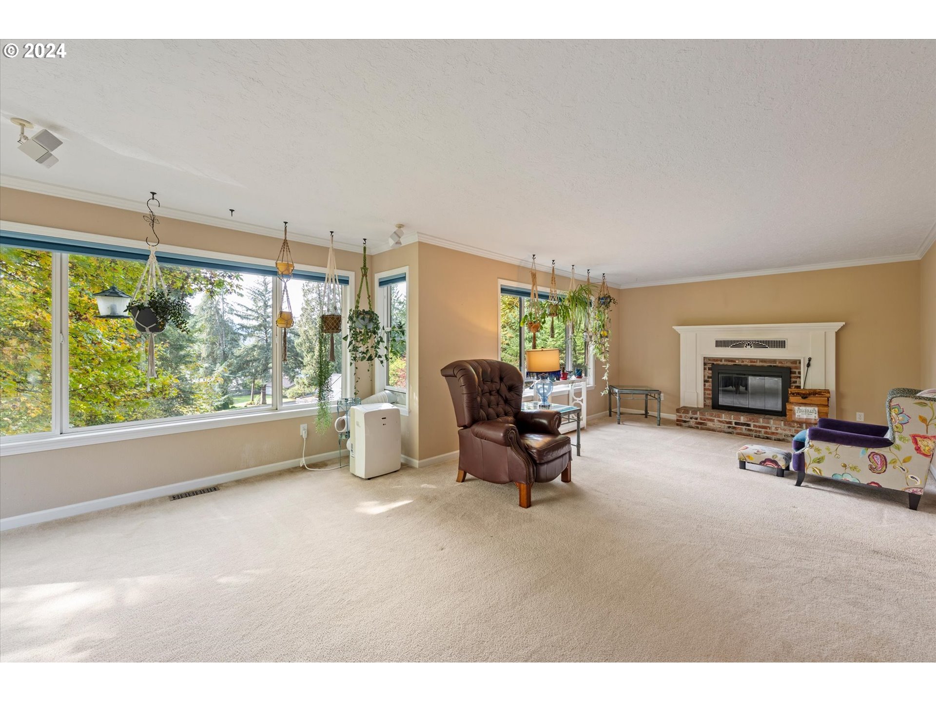 3516 Sunset Way Longview, WA 98632 - Photo 5 of 37 a living room with furniture a fireplace and a large window