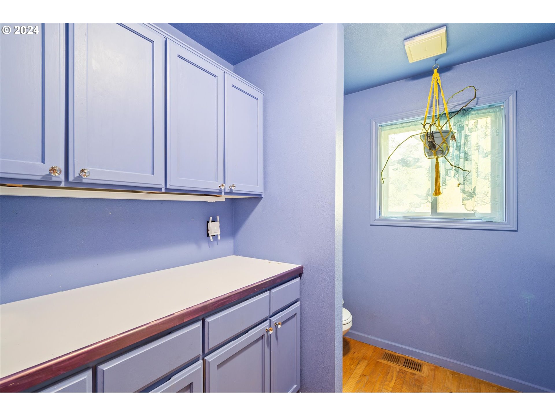 3516 Sunset Way Longview, WA 98632 - Photo 8 of 37 a kitchen with a sink cabinets and wooden floor
