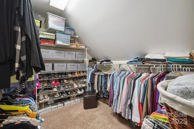 a bedroom with a bed and a book shelf
