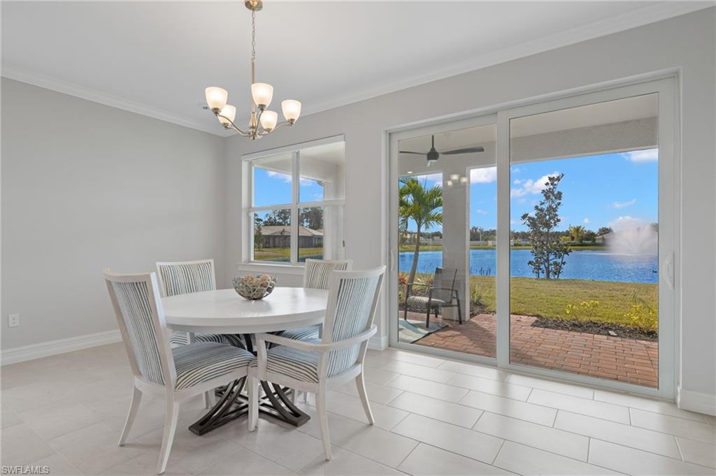 318 Deauville Loop Naples, FL 34114 - Photo 11 of 21 a dining room filled with furniture and chandelier