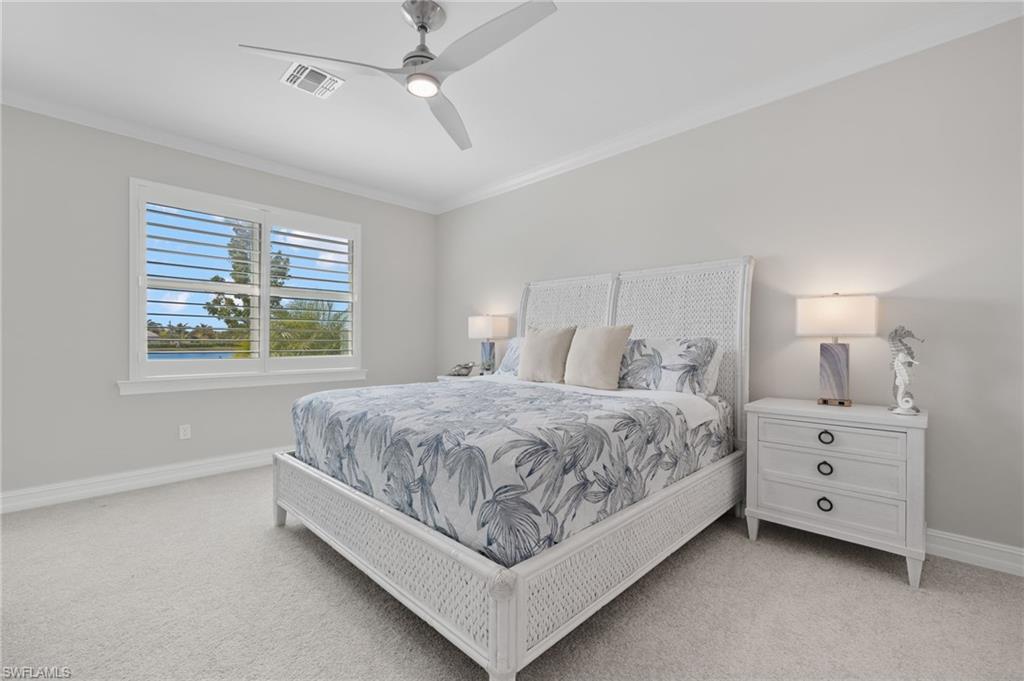 318 Deauville Loop Naples, FL 34114 - Photo 13 of 21 a spacious bedroom with a bed and a window