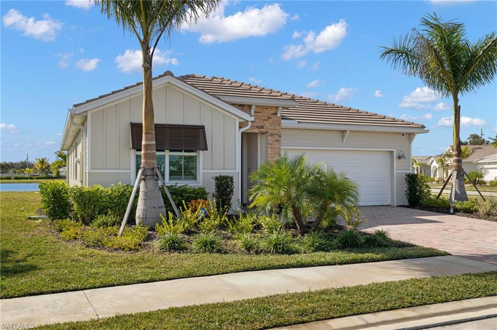 318 Deauville Loop Naples, FL 34114 - Photo 21 of 21 a front view of a house with garden
