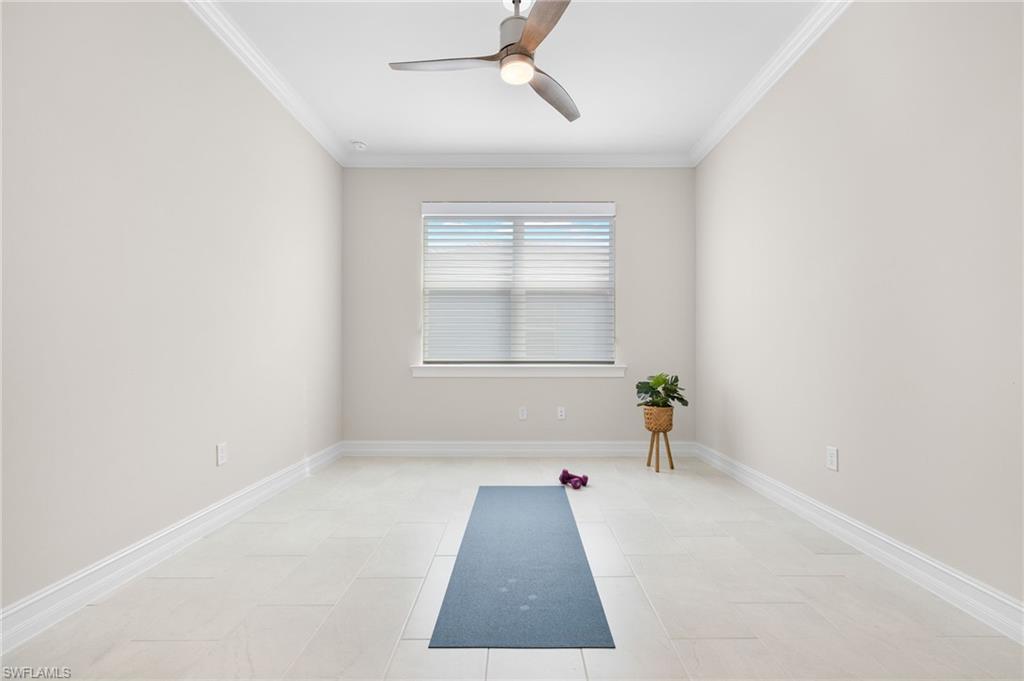 318 Deauville Loop Naples, FL 34114 - Photo 4 of 21 an empty room with a window and ceiling fan