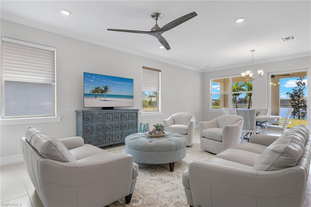 318 Deauville Loop Naples, FL 34114 - Photo 5 of 21 a living room with furniture a ceiling fan and a rug