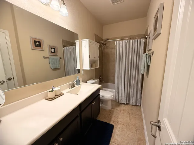 a bathroom with a sink a mirror and a toilet