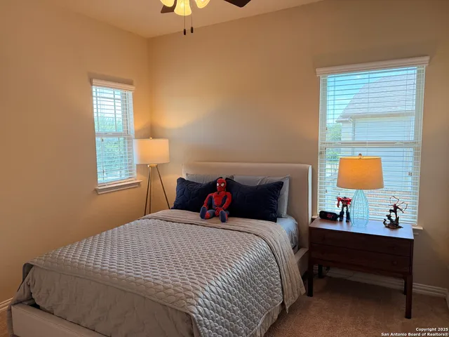 a bedroom with bed and window