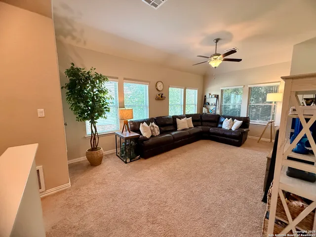 a living room with furniture a chandelier and a window