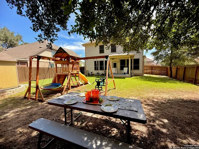 a view of a house with swimming pool and sitting area