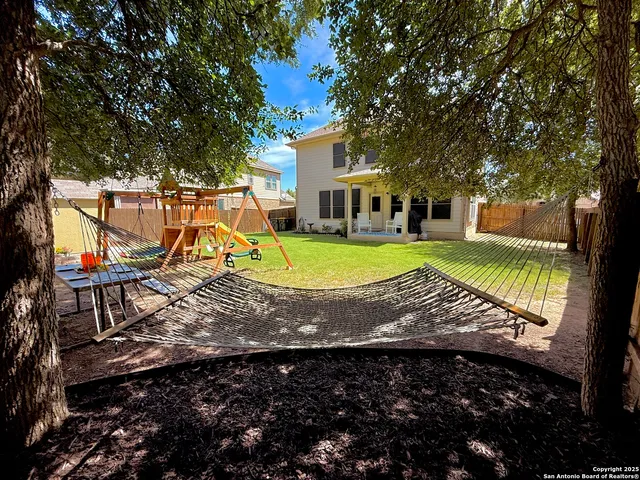 a view of a house with swimming pool and sitting area