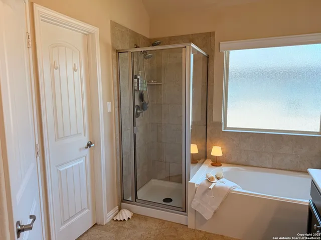 a bathroom with a shower and a sink
