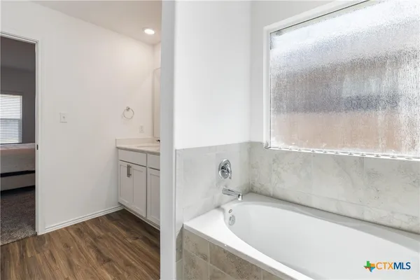 a bathroom with a bathtub and a sink