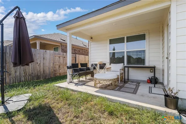 a view of a backyard with sitting area