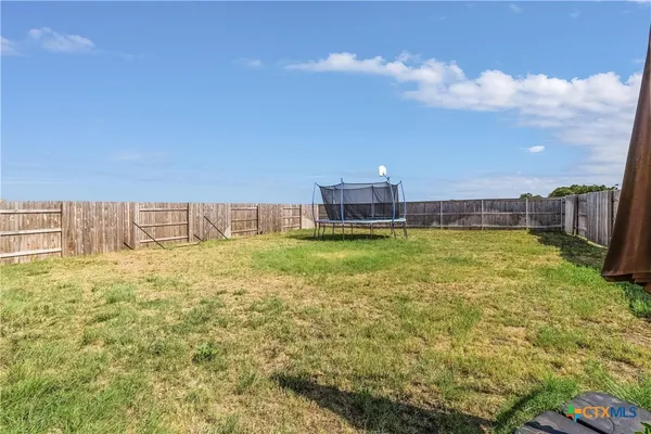 a view of a big yard with table and chairs