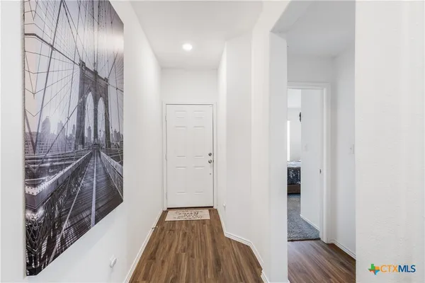 a view of hallway with wooden floor