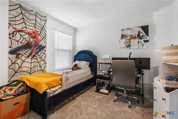 a bed room with a bed and a chair