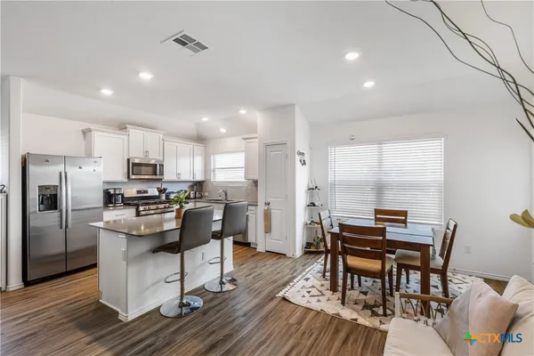 a kitchen with cabinets and stainless steel appliances