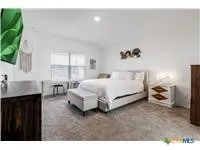 a bed room with a bed and a large window