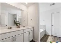 a en suite bathroom with a sink and a mirror