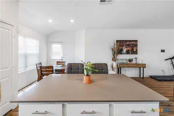 a living room with dining table and chairs