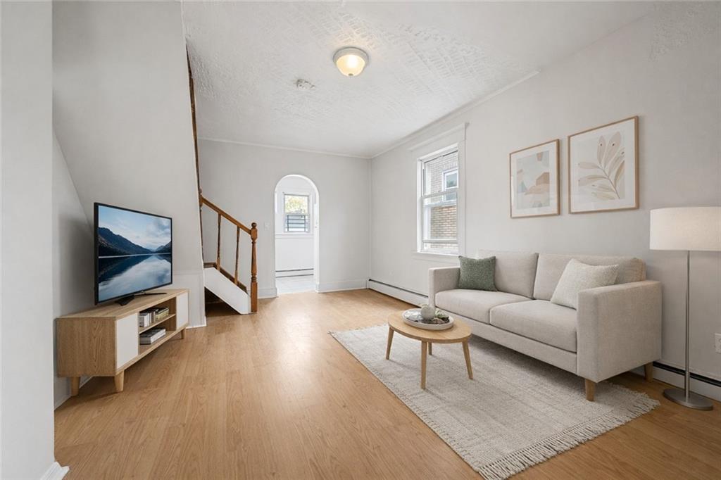 883 Manor Road Staten Island, NY 10314 - Photo 16 of 24 a living room with furniture and a flat screen tv
