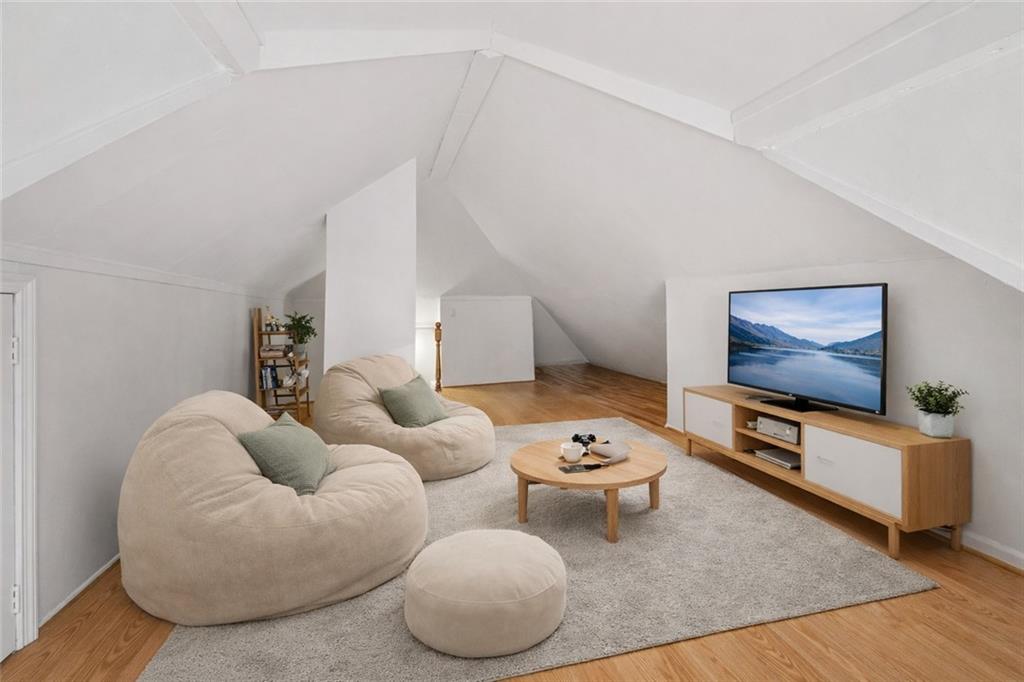 883 Manor Road Staten Island, NY 10314 - Photo 18 of 24 a living room with furniture and a flat screen tv