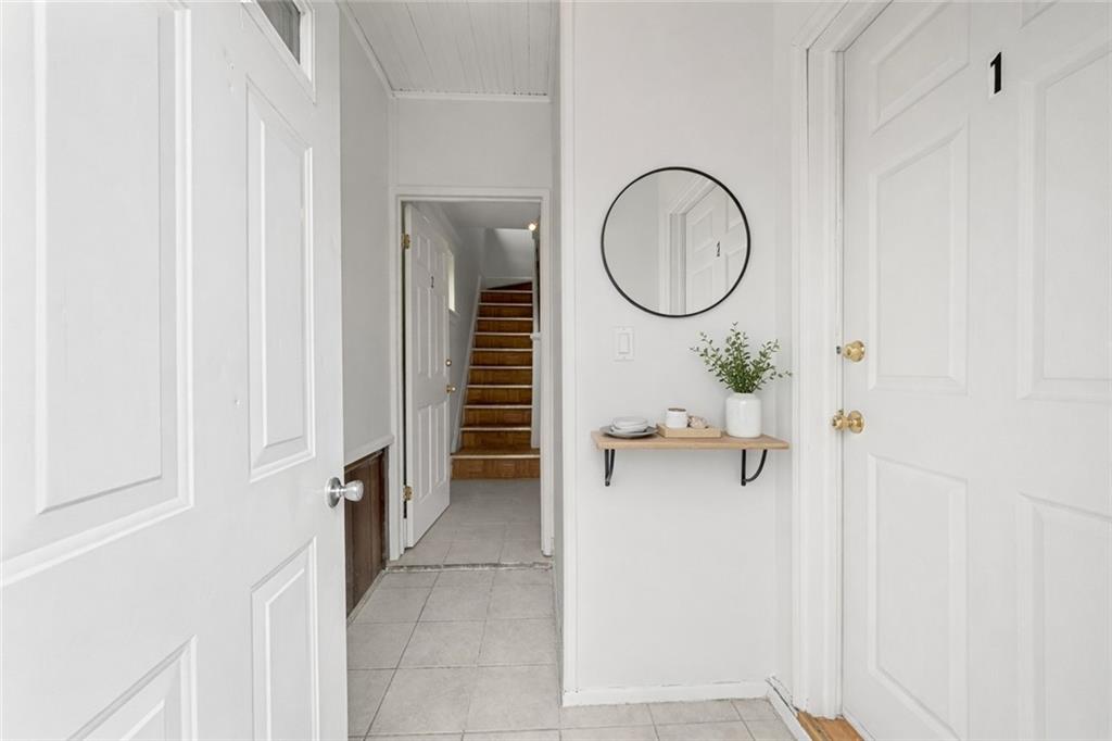 883 Manor Road Staten Island, NY 10314 - Photo 2 of 24 a view of a room with wooden floor and mirror