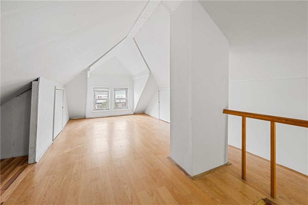 883 Manor Road Staten Island, NY 10314 - Photo 21 of 24 a view of an empty room with wooden floor and a window